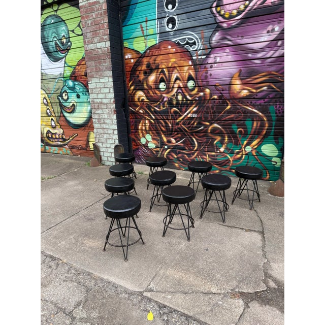 This is a set of 10 iron swivel stools in the style of Frederick Wineburg. They feature a robust black iron base and a...