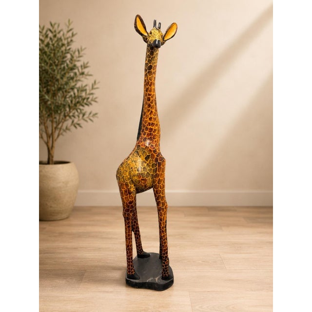 Bring warmth, artistry, and sculptural presence to your home with this impressive 60-inch hand-carved wooden giraffe...
