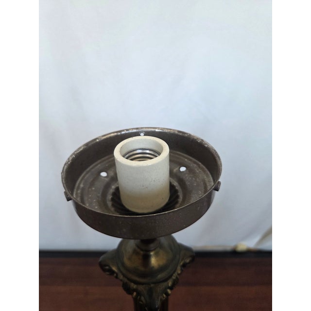 This antique cast spelter table lamp embodies the rich ornamental language of the late Neoclassical Revival, blending...