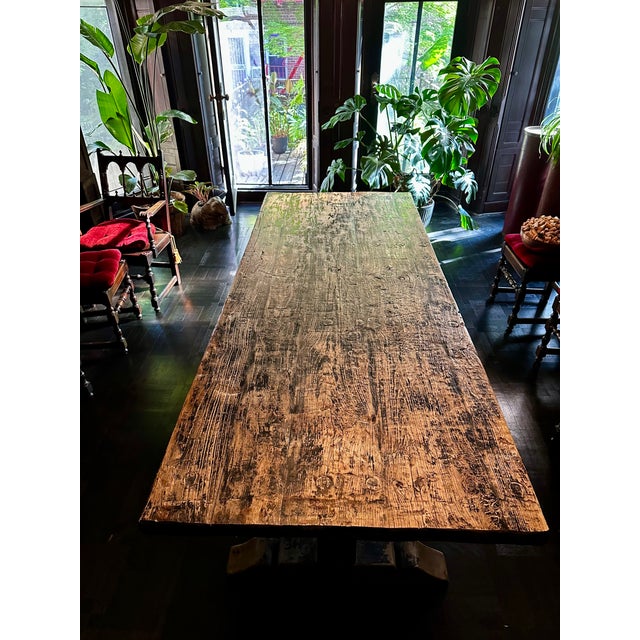 A truly striking, one-of-a-kind monumental trestle dining table crafted from thick reclaimed old-growth timber, showcasing...