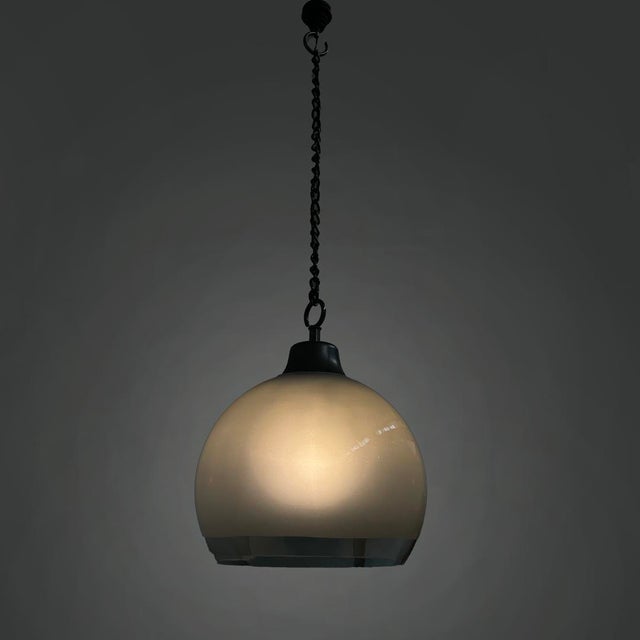 Set of three chandeliers model LS10 with double hook and metal chain. They feature a suspended Murano blown glass globe...