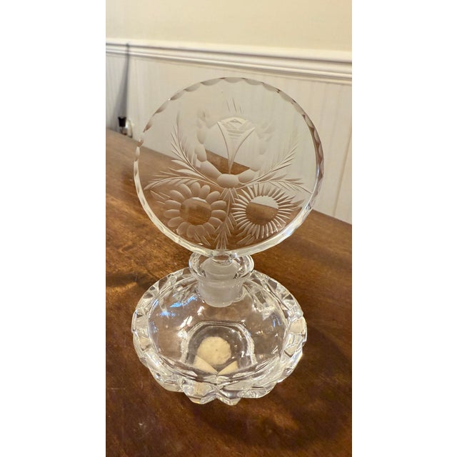This perfume bottle was designed to hold and dispense perfume but it will also serve as an elegant decorative piece for...