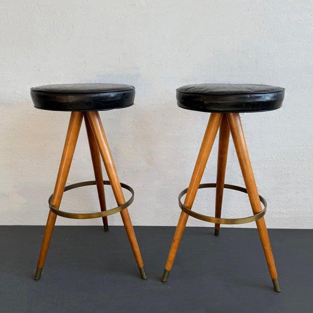 This sleek pair of mid-century modern bar stools strike the quintessential retro modern silhouette. They feature round...