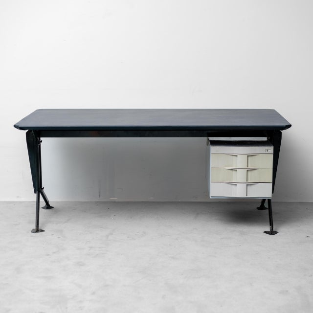 "ARCO" desk designed by BBPR for Olivetti. Featuring a simple metal frame and a suspended drawer unit. Blue leather top....