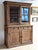 An early 19th-century French walnut bookshelf and cupboard, beautifully balanced in form and tone. The upper cabinet...