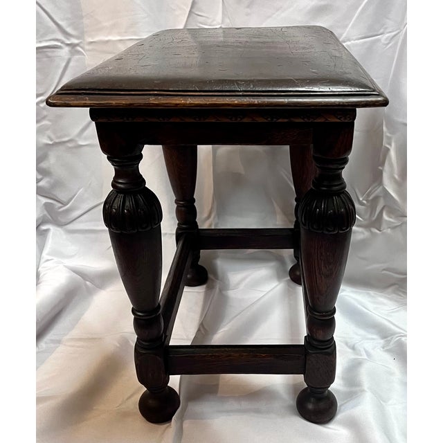 Antique English oak joint stool. Gently sloping top. Intricately carved turned legs. Stretcher frame. Popular from the...