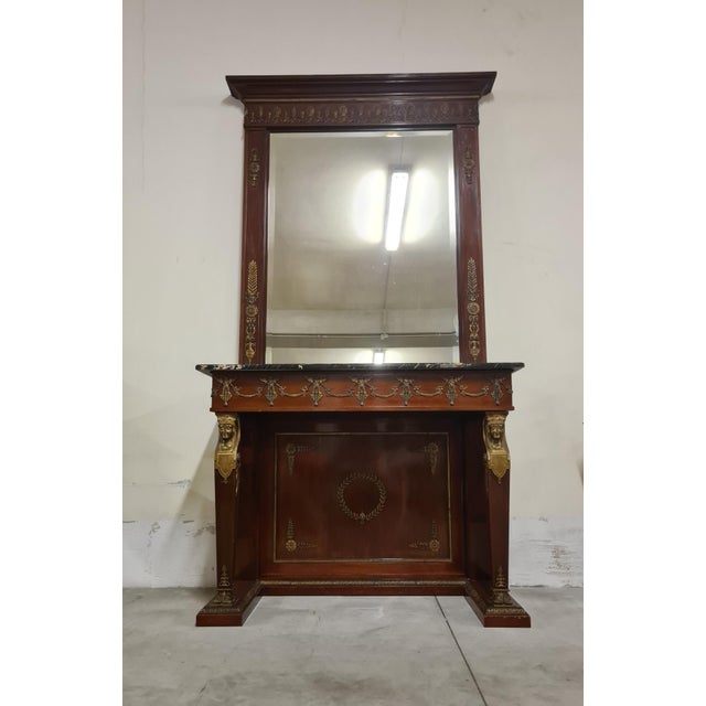 Retour d'Egypte Empire style console with mirror. Elegant and severe Empire style console with mirror made of wood with...