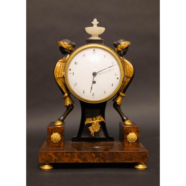 Refined small Biedermeier table clock, characterized by elegant proportions and representative of Central European...