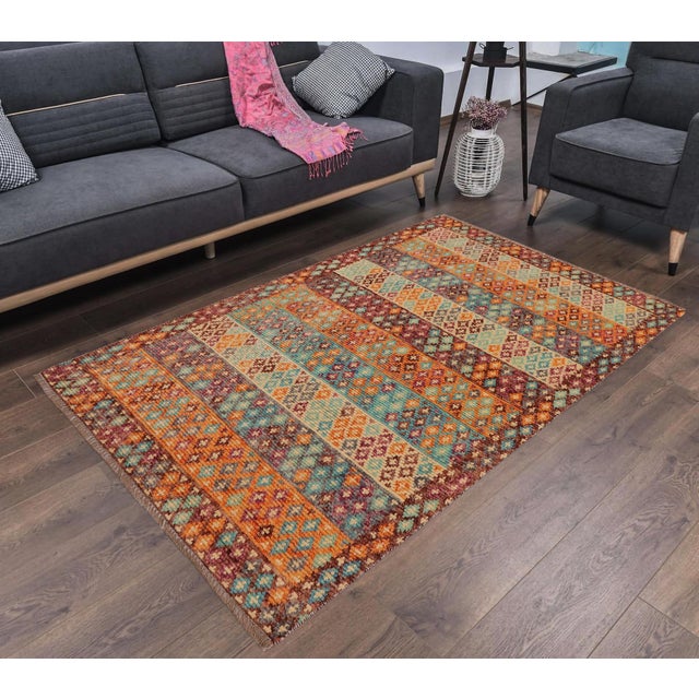 This stunning hand-knotted Afghan Balouchi rug is a captivating addition to any decor. Crafted by skilled artisans, it...