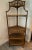 Offered is stunning vintage pagoda top etagere. Made from rattan and wicker, it has five tiers with wicker shelves....
