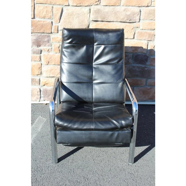 For a touch of mid-century modern comfort, consider this gleaming chrome and black leatherette recliner designed by Milo...