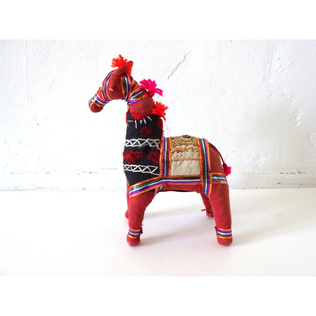 A vintage Indian Banjara horse, made of colorful linens and cottons, embroidery threads, ribbons, and yarn tassels, with...