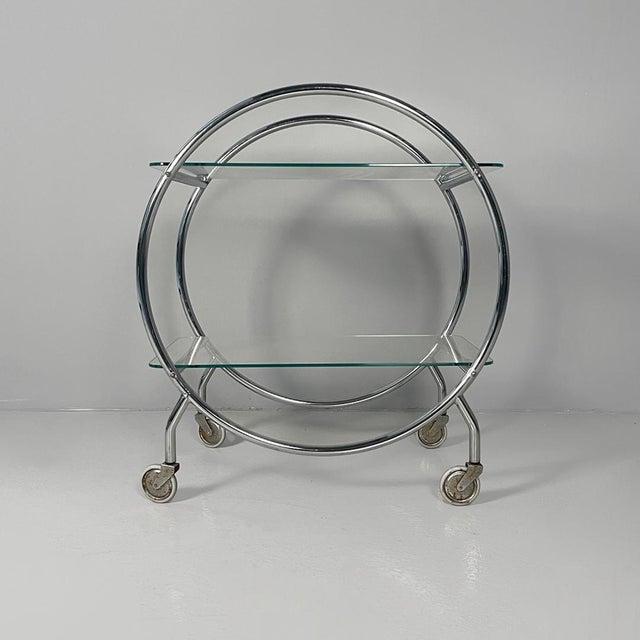 Italian modern cart in steel and glass with casters, 1970s Serving cart or food cart with a chromed metal frame. It...