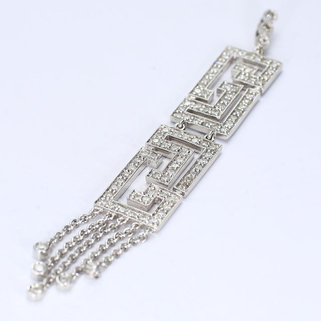 Here is a fun 18k white gold necklace with a Maze shape and general art deco styling. It has ninety-seven SI2/G diamonds...