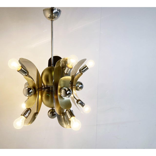 Unique chromed and brass chandelier from the space age area. The chandelier is made of chromed and brass bent metal...