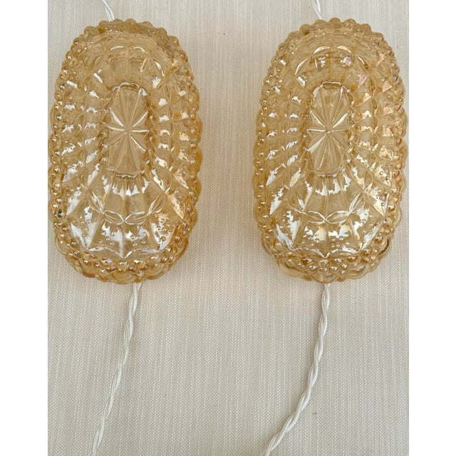 This pair of stunning vintage iridescent bubble glass sconces will add a romantic golden glow to your room. They are newly...