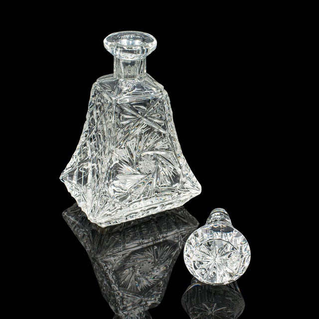 This is a distinguished mid 20th century brandy decanter, showcasing exquisite English cut glass craftsmanship, circa...