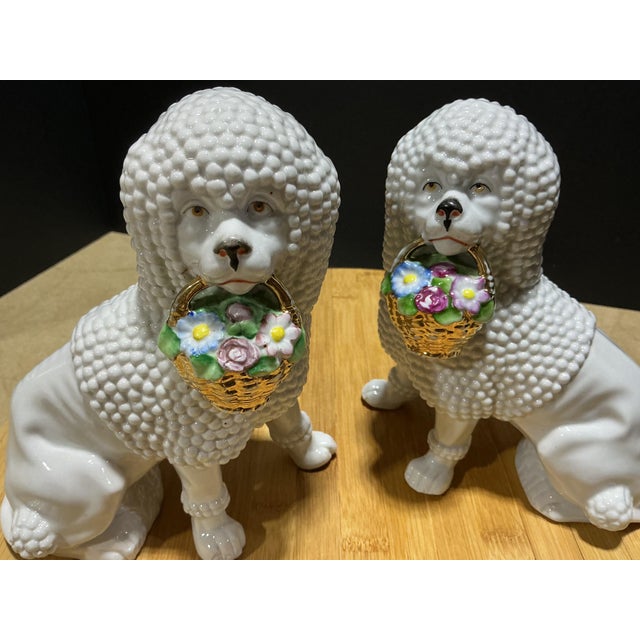 Charming and highly detailed, this vintage pair of white porcelain poodles brings delightful mid-century whimsy to any...
