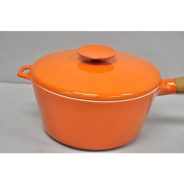 Vintage Copco Michael Lax Orange Enameled Cast Iron Saucepan Denmark MCM with Lid. Circa Late 20th Century. Measurements:...
