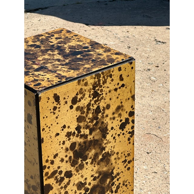 Tall and slender pedestal with a high-impact faux tortoiseshell finish in deep amber and black tones. Square form with...