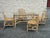 Vintage rattan dining set featuring a rectangular glass-top table and four matching dining chairs. Sculptural bent rattan...