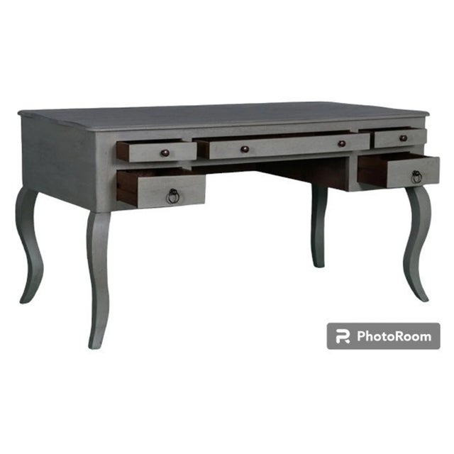 This Queen Anne dressing table is crafted from solid wood with cabriole legs and a soft gray finish, offering a large...