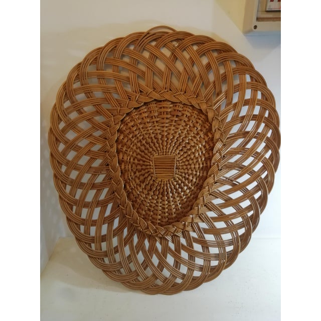 Beautiful woven wicker mirror with a triangular plectrum shape. The shape is unique because I've seen very few like it....
