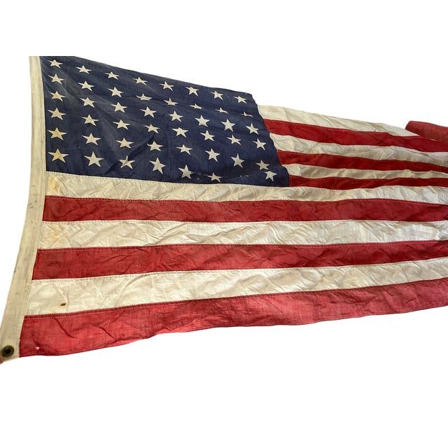 Authentic 48-star U.S. flag dating to the period between 1912 and 1959, when the flag featured forty-eight stars...