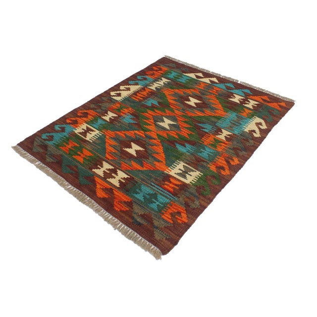 Add a touch of elegance to your home with this casual chic hand woven Tribal Kilim wool rug. Constructed on a loom by...