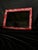 Rectangular wall mirror with a layered frame in a distressed red finish. The finish was applied by hand in the LOOM...
