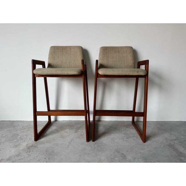 Beautiful pair of authentic 1960’s Mid-Century Danish Modern bar stools, crafted in solid teak with clean architectural...