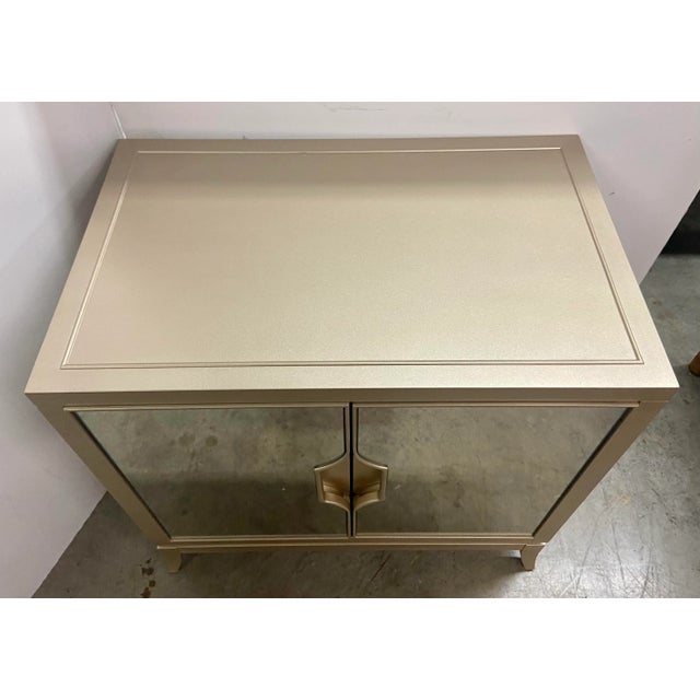 Original Retail $2120. Stylish Caracole Compositions Modern Adela Nightstand, blush taupe finished wood body, two mirrored...