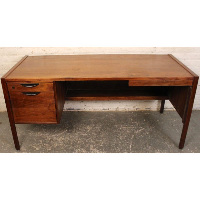 This is stunning Jens Risom walnut executive desk. The piece is incredibly sturdy and features stunning grain patterns....