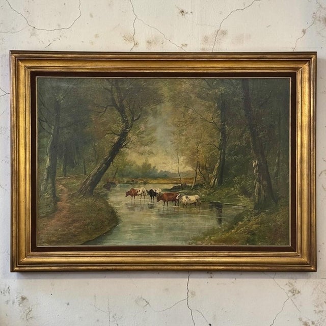 A pleasing pastoral European oil on canvas by J. Vanlint, “River Landscape with Cows” captures the quiet beauty of the...