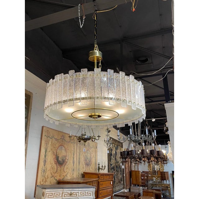 Exquisite shaped drum shaped modern Murano glass and brass chandelier. Beautiful textured glass on a decorative base. So...
