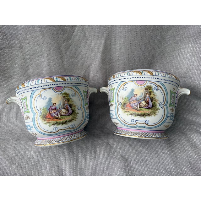 Antique set of 2 Royal Rudolstadt hand painted bisque cache pots each with small handles. Each with ornated painted...