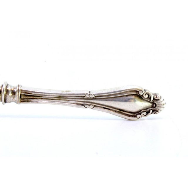 Silver Spaghetti Spoon with Stylized Handle and Shells Embossed Ladle, in Very Good conditions. Designed 1890 to 1919 This...