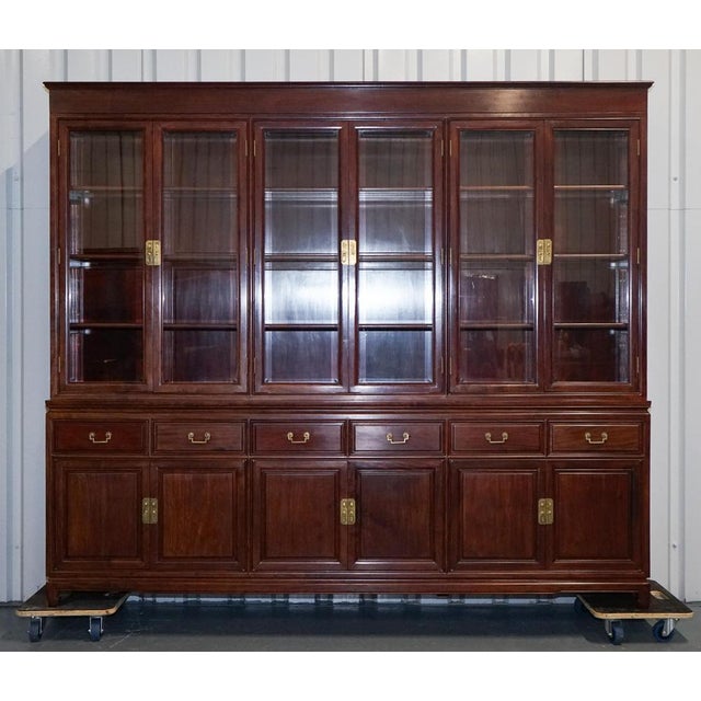 This impressive and generously scaled Chinese bookcase display cabinet is crafted from richly toned teak, offering both...