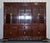 This impressive and generously scaled Chinese bookcase display cabinet is crafted from richly toned teak, offering both...