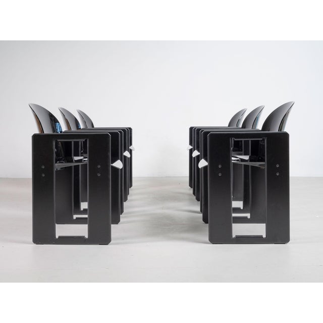 Set of six Dialogo chairs with structure in black lacquered wood, seat and back in black fiberglass and metal details. It...