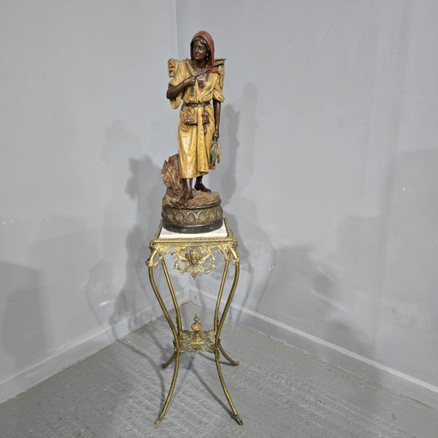 Austro-Hungarian cold painted terracotta statuette of a barefoot fishergirl, probably Bernard Bloch, c1900, carrying a...