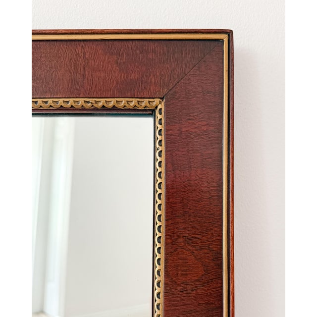 Large vintage Federal-style rectangular mirror with a warm mahogany-finish frame and parcel-gilt trim. Features a classic...