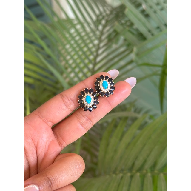 These elegant floral-inspired cluster stud earrings are crafted in 14K yellow gold and feature vibrant turquoise center...