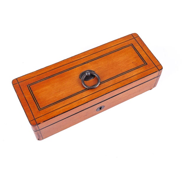 English satinwood glove box from the Victorian period circa 1870. Its lid and sides trimmed with fine ebony line inlay and...