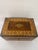 This Antique Marquetry Inlaid Wooden Jewelry Box is a beautifully crafted piece with a geometric pattern. It may be...