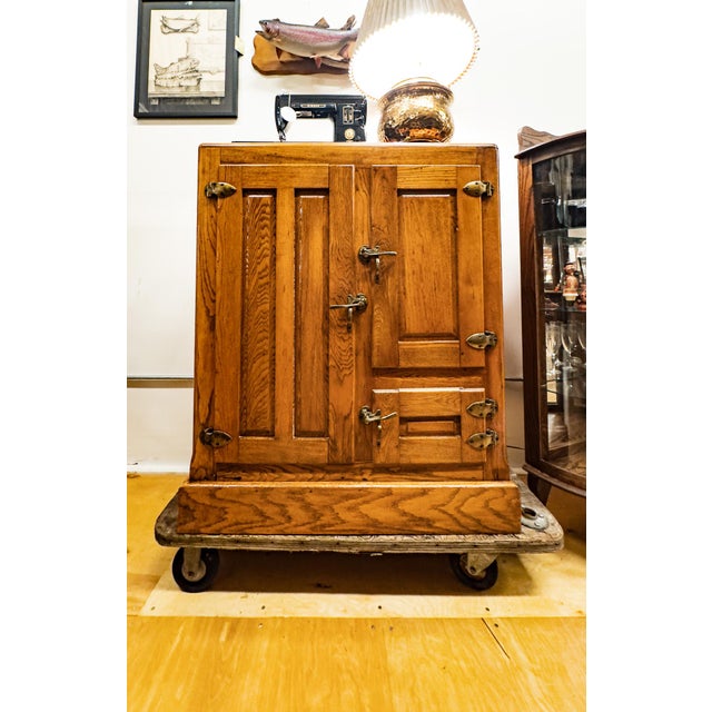 A charmer of an antique oak ice box that is in very good shape.