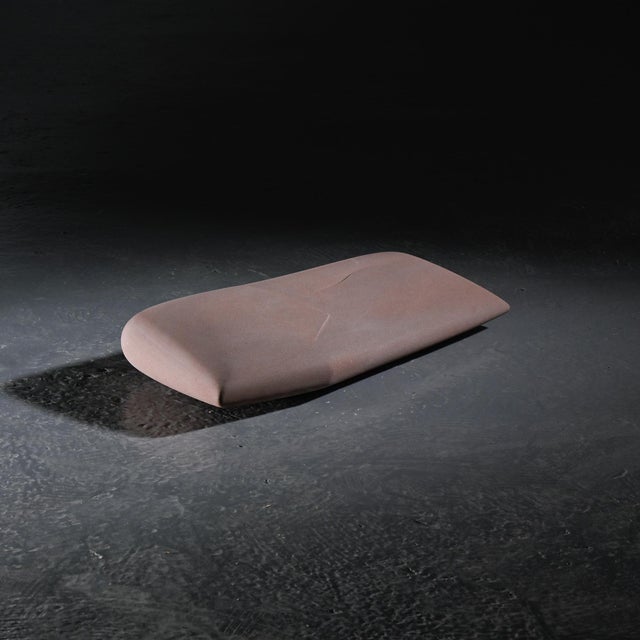 A sandstone sculpture created by Robert Neuhauser in Switzerland around the mid-1980s. Deployed horizontally, the piece is...