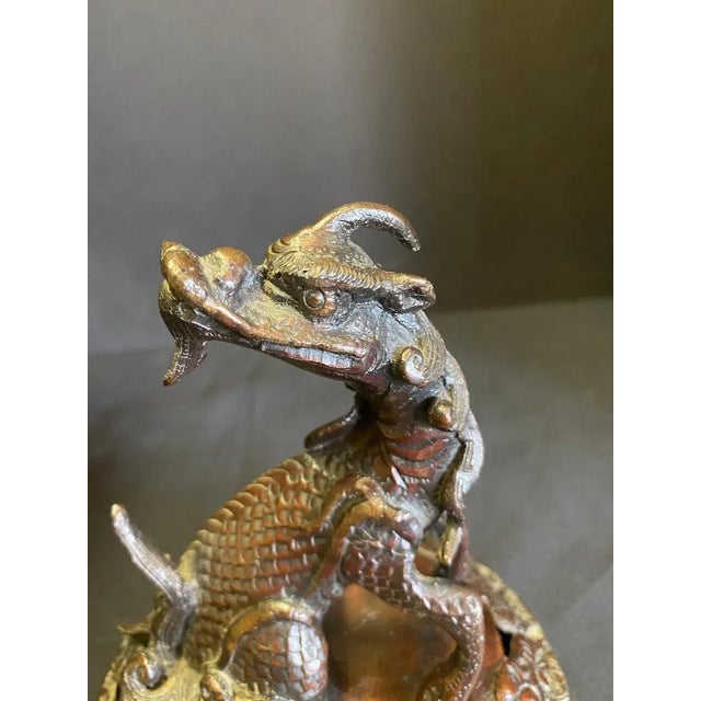 Bronze Urn Incense Burner with fine detail and birds in four distinctive panels and topped with a dragon. Measures 21...