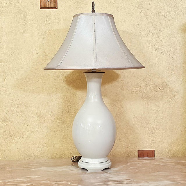 Elegant vintage ceramic urn-form table lamp, likely late 20th century, circa 1980s–1990s. The glossy cream/off-white...