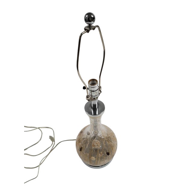 Embrace coastal charm with this exquisite table lamp. The glass body features natural seashell inclusions, bringing rich...